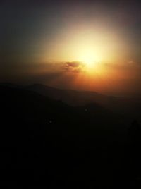 Silhouette of mountain range at sunset