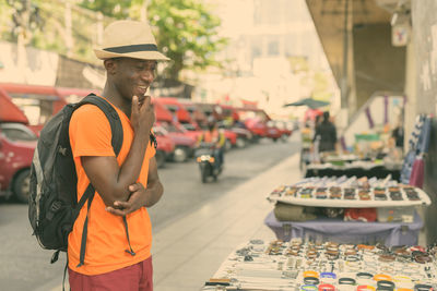 Man standing on street in city