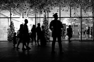 Silhouette people on city street during christmas