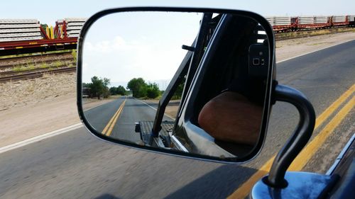 Close-up of car on road against sky