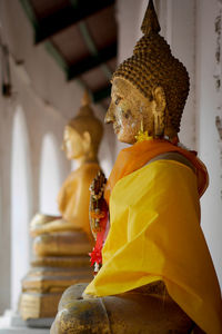 Statue of buddha against building