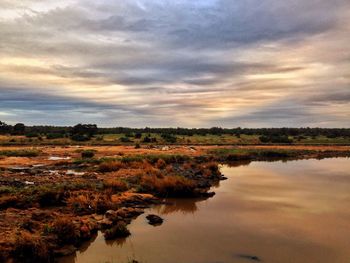 Scenic view of landscape against sky at sunset