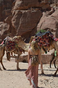 Side view of woman walking on sand