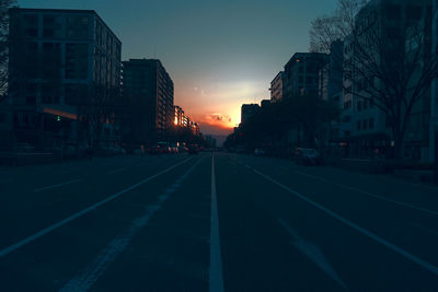 View of city street at sunset
