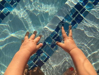 Midsection of person swimming in sea