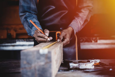 Midsection of worker working in workshop