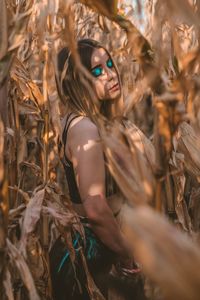 Young woman standing amidst plants