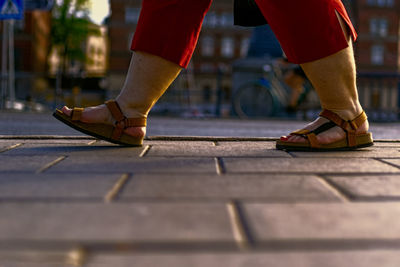 Low section of man walking on footpath