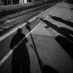 Shadow of people on road