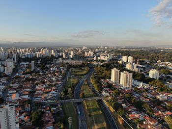 High angle view of illuminated city buildings against sky