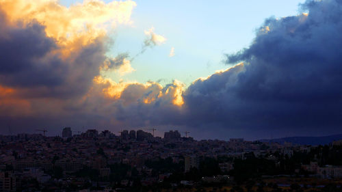 Panoramic shot of cityscape against sky during sunset
