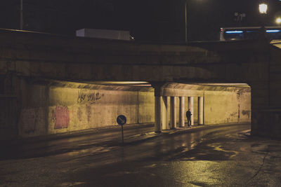 Man in illuminated tunnel