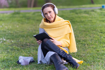 Young woman sitting on field