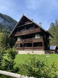 Exterior of old house by building against sky