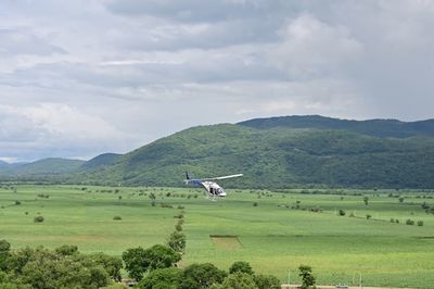 Scenic view of green landscape against sky