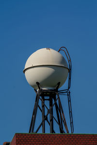 Low angle view of building against clear blue sky