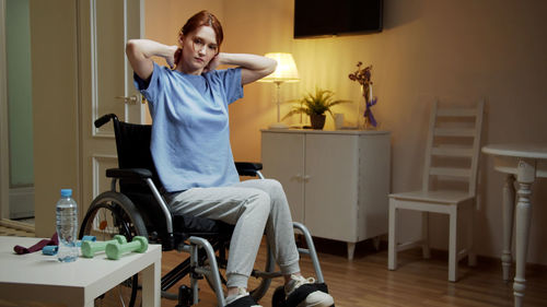 Portrait of smiling woman sitting on wheelchair