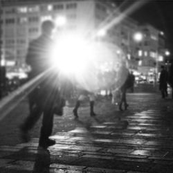 Silhouette of woman walking in city