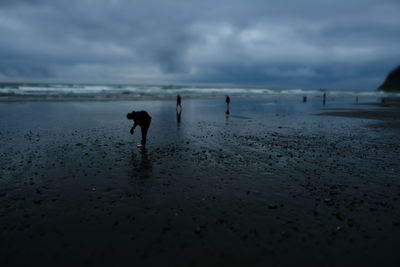 Full length of man on beach against sky