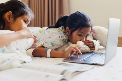 Side view of boy using laptop at home