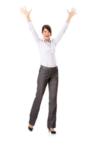 Full length of happy young woman standing against white background