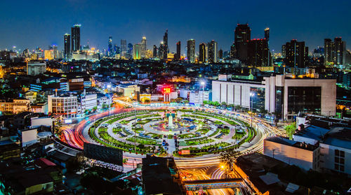 High angle view of city lit up at night