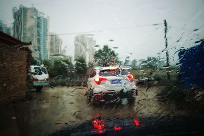 Car on rainy day seen through car windshield