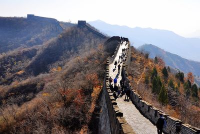 People on mountain road against sky