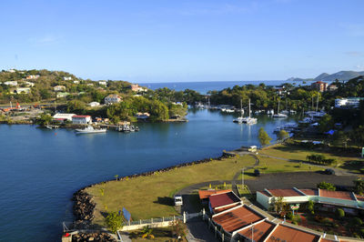 High angle view of townscape by sea against sky