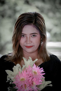 Portrait of young woman wearing flowers