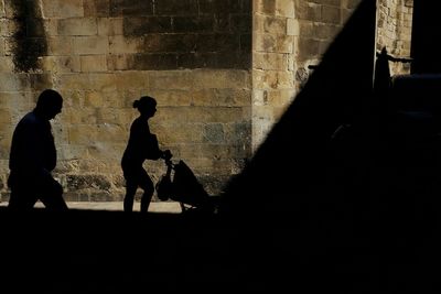 Silhouette of woman against wall