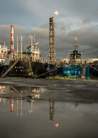 River by factory against sky