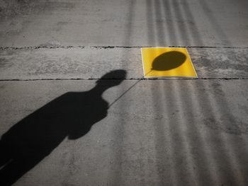 High angle view of person shadow on street