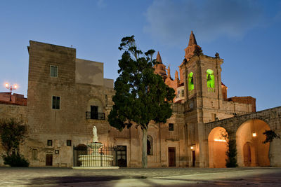 Low angle view of historical building at night against sky