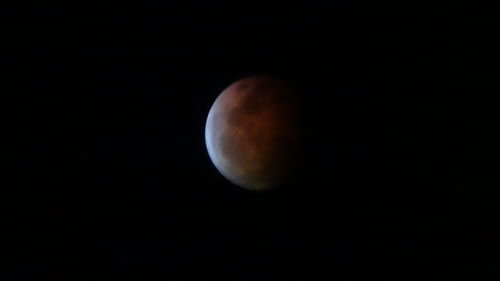 Low angle view of moon against sky at night