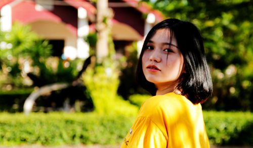 Portrait of woman against plants