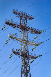 Line insulator on the electrical wires of a high-voltage tower. 