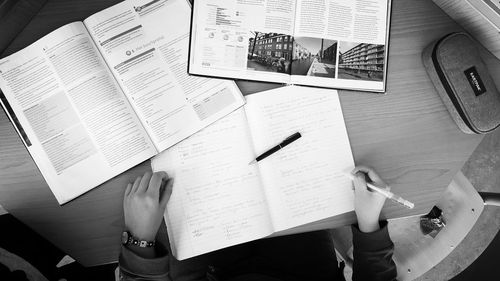 Low section of woman with text on paper