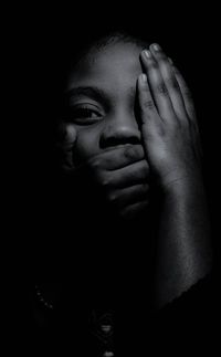 Close-up portrait of baby girl in darkroom