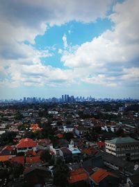 Cityscape against cloudy sky