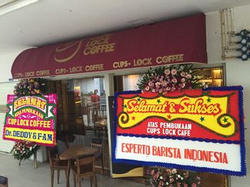 Close-up of signboard against store