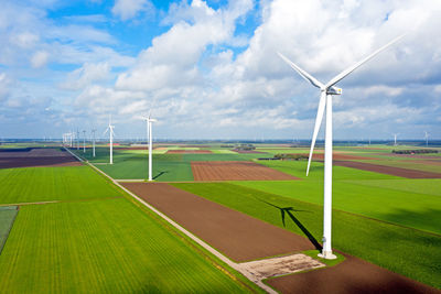 Windmill on field against sky