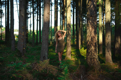 Young woman standing in forest