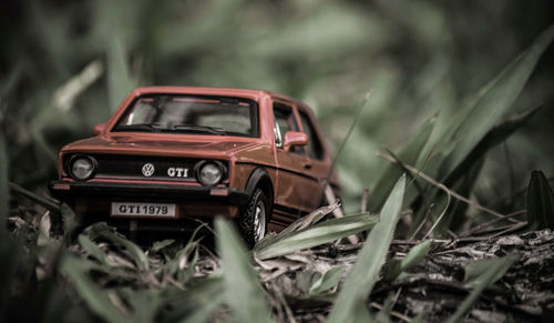 Close-up of abandoned car on field