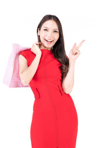 Portrait of smiling young woman against white background