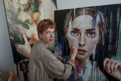 Female artist painting on canvas in studio