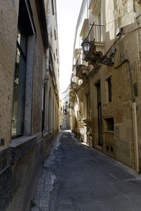 Narrow alley amidst buildings in city