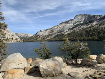 Scenic view of lake by mountains against sky