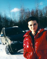 Portrait of man standing in car