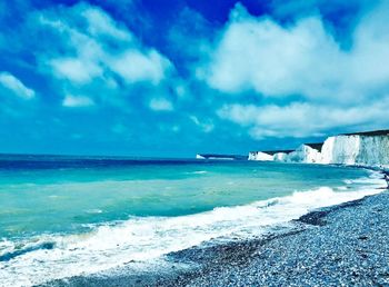 Scenic view of sea against cloudy sky